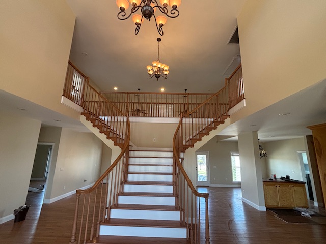 Grand two-story staircase and chandelier foyer interior painting