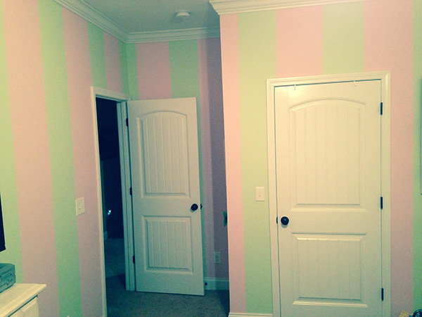Playful custom striped accent wall for a kid's room